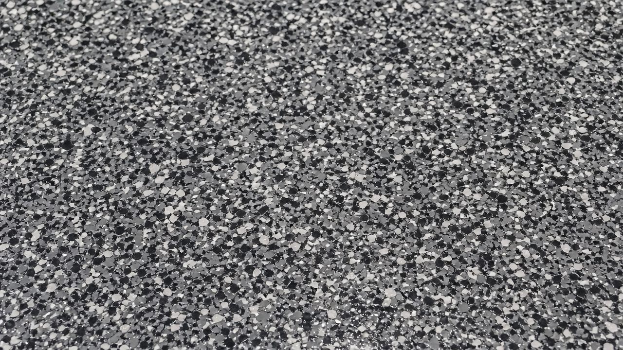 Close view of a grey, black and white epoxy flake floor