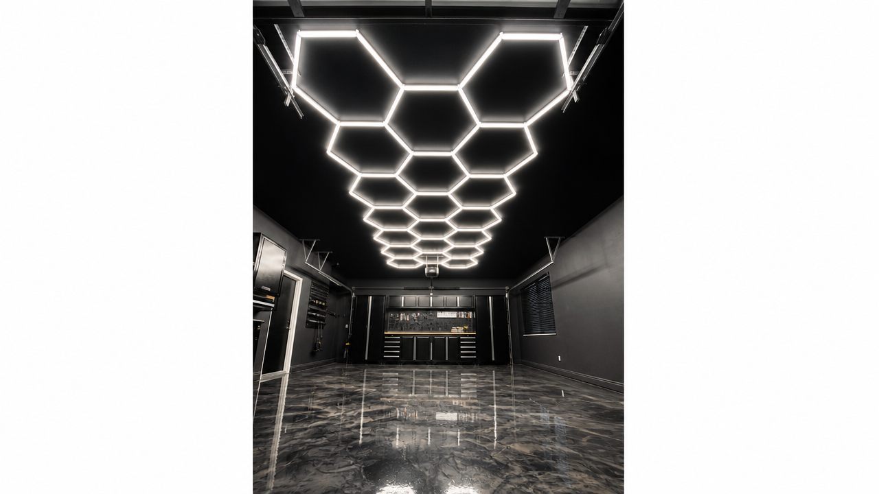 Hexagonal LED light array above a dark metallic epoxy floor, reflecting the lights
