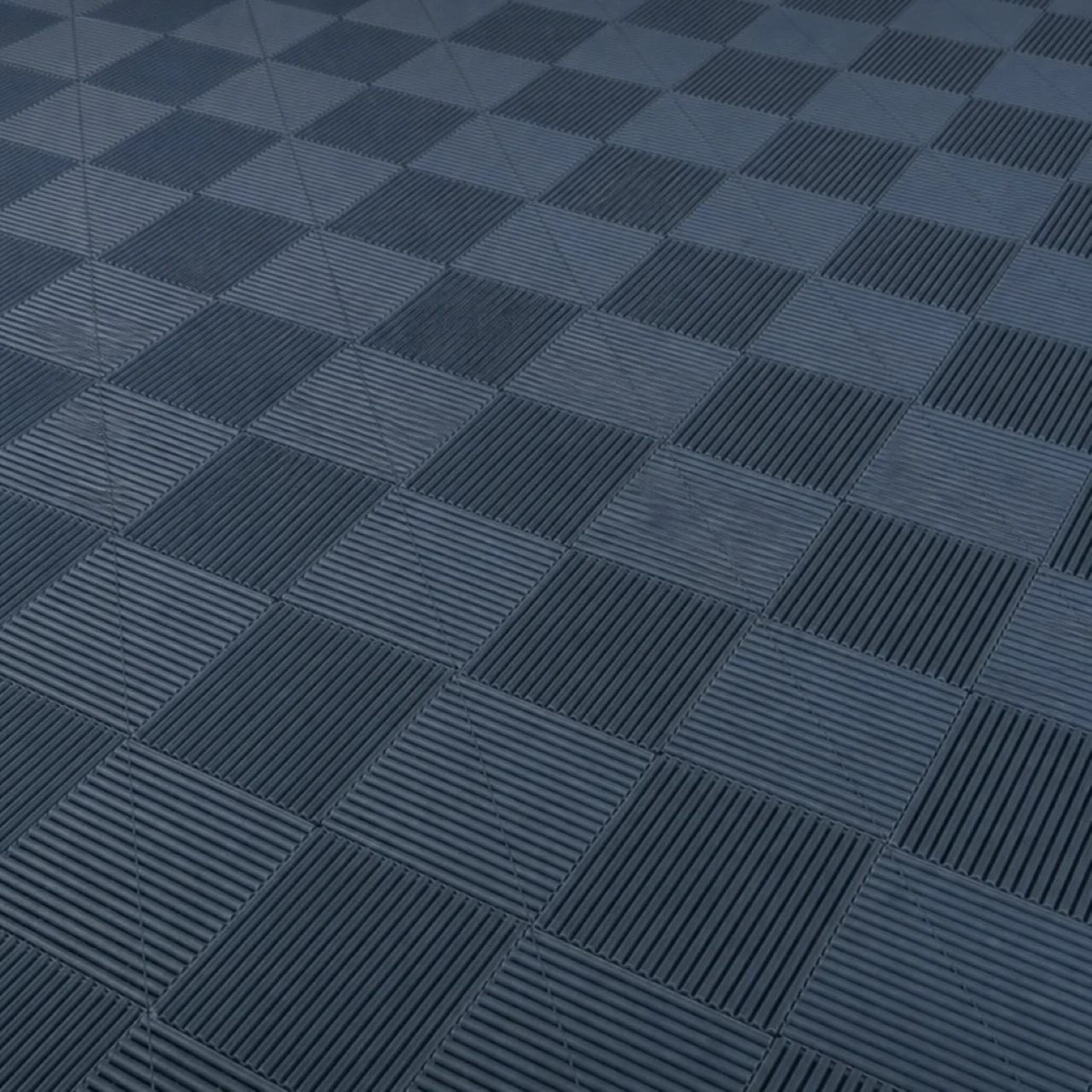 Close-up of dark grey interlocking PVC garage floor tiles in a clean grid pattern